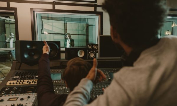 sound producers showing thumbs up to singer at recording studio