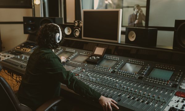 sound producer working at studio while recording song